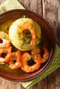 Mofongo Garlic-Flavored Mashed Plantains: a very tasty dish served with shrimp close-up on a plate. Vertical top view