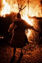 Mohacs, Baranya / Hungary - FEB 26 2017 : traditional woman participant of the busojaras event in front of the large bonfire