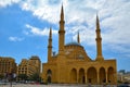 The Mohammad AlAmin Mosque or Blue Mosque with four minarets, in the background is the church of St. George in Beirut, Lebanon