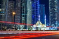 Mohammed Bin Ahmed Almulla mosque with buidings and light trails at night in Dubai Royalty Free Stock Photo