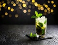 Mohito drink with rum, mint, sugar, lime slices and ice cubes. New Year\'s party