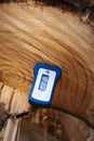 A Moisture meter reading the water content of a newly felled tree.
