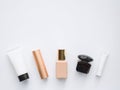 moisturizing creams for face and eyes, perfume, foundation and lipstick - cosmetics on white background, copy space