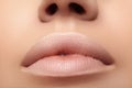 Moisturizing lip, lipstick. Close-up beautiful lips. Full lips with natural makeup. Filler Injections, Plastic Surgery Royalty Free Stock Photo