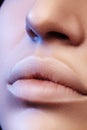 Moisturizing lip balm, lipstick. Close-up of beautiful lips. Full lips with natural lip makeup. Filler Injections Royalty Free Stock Photo