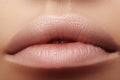 Moisturizing lip balm, lipstick. Close-up of beautiful lips. Full lips with natural lip makeup. Filler Injections Royalty Free Stock Photo