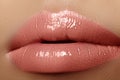 Moisturizing lip balm, lipstick. Close-up of a beautiful wet lips. Full lips with gloss makeup. Filler Injections Royalty Free Stock Photo