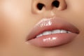 Moisturizing lip balm, lipstick. Close-up beautiful wet lips. Full lips with gloss lip makeup. Filler Injections Royalty Free Stock Photo