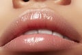 Moisturizing lip balm, lipstick. Close-up of a beautiful wet lips. Full lips with gloss makeup. Filler Injections Royalty Free Stock Photo