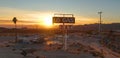 DRONE: Flying around abandoned gas station and diner in Mojave desert at sunset. Royalty Free Stock Photo