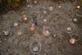 Night light candles burning in upcycled glass jars in desert