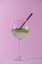 Mojito alcohol cocktail, tropical beverage with ice, mint and lime on pastel pink background with copy space Royalty Free Stock Photo