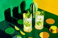 Mojito alcoholic cocktail with ice on colourful background. modern cocktails drinks design concept