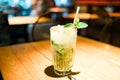 Mojito alcoholic cocktail with mint, lime slices and ice on a bar.Selective focus image