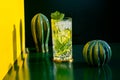 Mojito alcoholic cocktails with alcohol, rum lime, mint and ice with hard lights on colorful background. Mixology details and