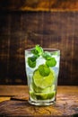 Mojito cocktail at the bar. Mojito cocktail over rustic wood. Cold Mojito, rum, lime and mint tourist drink Royalty Free Stock Photo