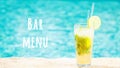 Mojito cocktail at the edge of a resort pool. Concept of luxury vacation. Bar menu wording Royalty Free Stock Photo