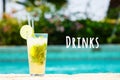 Mojito cocktail at the edge of a resort pool. Concept of luxury vacation. Drinks wording Royalty Free Stock Photo