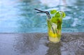 Mojito cocktail at the edge of a resort pool. Concept of luxury vacation Royalty Free Stock Photo