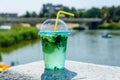 Mojito cocktail on a granite parapet with river on background