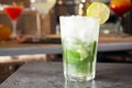 Mojito cocktail on grey table in bar. Space for text Royalty Free Stock Photo
