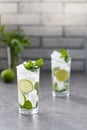 Mojito cocktail with lime and mint in glass. Mojito cocktail on dark stone table Royalty Free Stock Photo