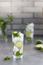 Mojito cocktail with lime and mint in glass. Mojito cocktail on dark stone table Royalty Free Stock Photo