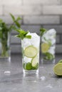 Mojito cocktail with lime and mint in glass. Mojito cocktail on dark stone table Royalty Free Stock Photo