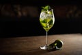 Mojito cocktail with lime and mint in highball glass on a dark stone background Royalty Free Stock Photo