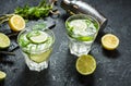 Mojito cocktail with lime and mint in highball glass on a stone table. Drink making tools and ingredients for cocktail Royalty Free Stock Photo