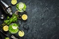 Mojito cocktail with lime and mint in highball glass on a stone table. Drink making tools and ingredients. Copy space and top view Royalty Free Stock Photo