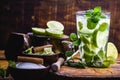Mojito cocktail with lime, rum and mint in the tall glass on a rustic wooden table. Summer drink made in Havana Royalty Free Stock Photo
