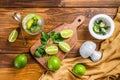 Mojito cocktail making. Ingredients Mint, lime, ice and bar utensils. Wooden background. Top view Royalty Free Stock Photo