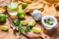 Mojito cocktail making. Ingredients Mint, lime, ice and bar utensils. Wooden background. Top view Royalty Free Stock Photo