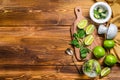 Mojito cocktail making. Ingredients Mint, lime, ice and bar utensils. Wooden background. Top view. Copy space Royalty Free Stock Photo