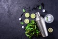 Mojito Cocktail Making. Mint, Lime, Ice, Glass and Bar Shaker on Dark Stone Table. Copy Space For Your Text Royalty Free Stock Photo