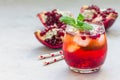 Mojito cocktail with pomegranate, mint, lemon juice and ice in glass, copy space Royalty Free Stock Photo