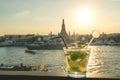 Mojito cocktail on table in rooftop bar with famous place background. Wat Arun ,Bangkok ,Thailand