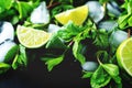 Mojito coctail ingredients with fresh mint leaves and lime slices on a black background Royalty Free Stock Photo