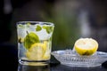 Mojito drink in a transparent glass on wooden surface with white rum,soda,lemon juice,fresh mint leaves,ice cubes and sugar,Close Royalty Free Stock Photo