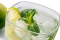 Mojito glass with mint leaves, sliced lime and ice close-up on white background Royalty Free Stock Photo