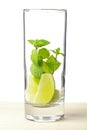 Mojito mix: lime, mint in glass on wood table Royalty Free Stock Photo