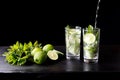 Mojito traditional beach refreshing cocktail alcohol drink in glass bar preparation pouring soda water, lime, mint Royalty Free Stock Photo
