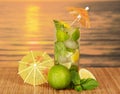 Mojito with umbrellas against sea sunset Royalty Free Stock Photo