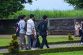 Mojokerto, Indonesia - 06-26-2023: a group of young people are walking around a green park, enjoying the weekend with friends