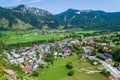 Mojstrana village in Slovenia - aerial view on a bright, sunny day, with Karawanks mountain range visible in the back.
