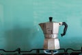 Moka coffe on gas flame. Italian typical coffee tool. Espresso coffe with light blue background and copy space Royalty Free Stock Photo