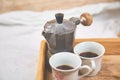 Moka coffee pot with two cup of coffe on wooden tray Royalty Free Stock Photo