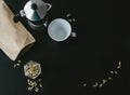 Moka pot on black background with cardamon seeds