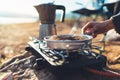 Moka pot coffee campsite morning lifestyle, person cooking hot drink in nature camping outdoor, cooker prepare breakfast picnic